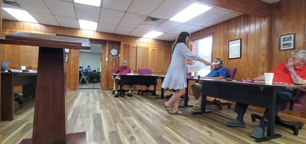 Jaclyn James, Clinch County Administrator distributing papers